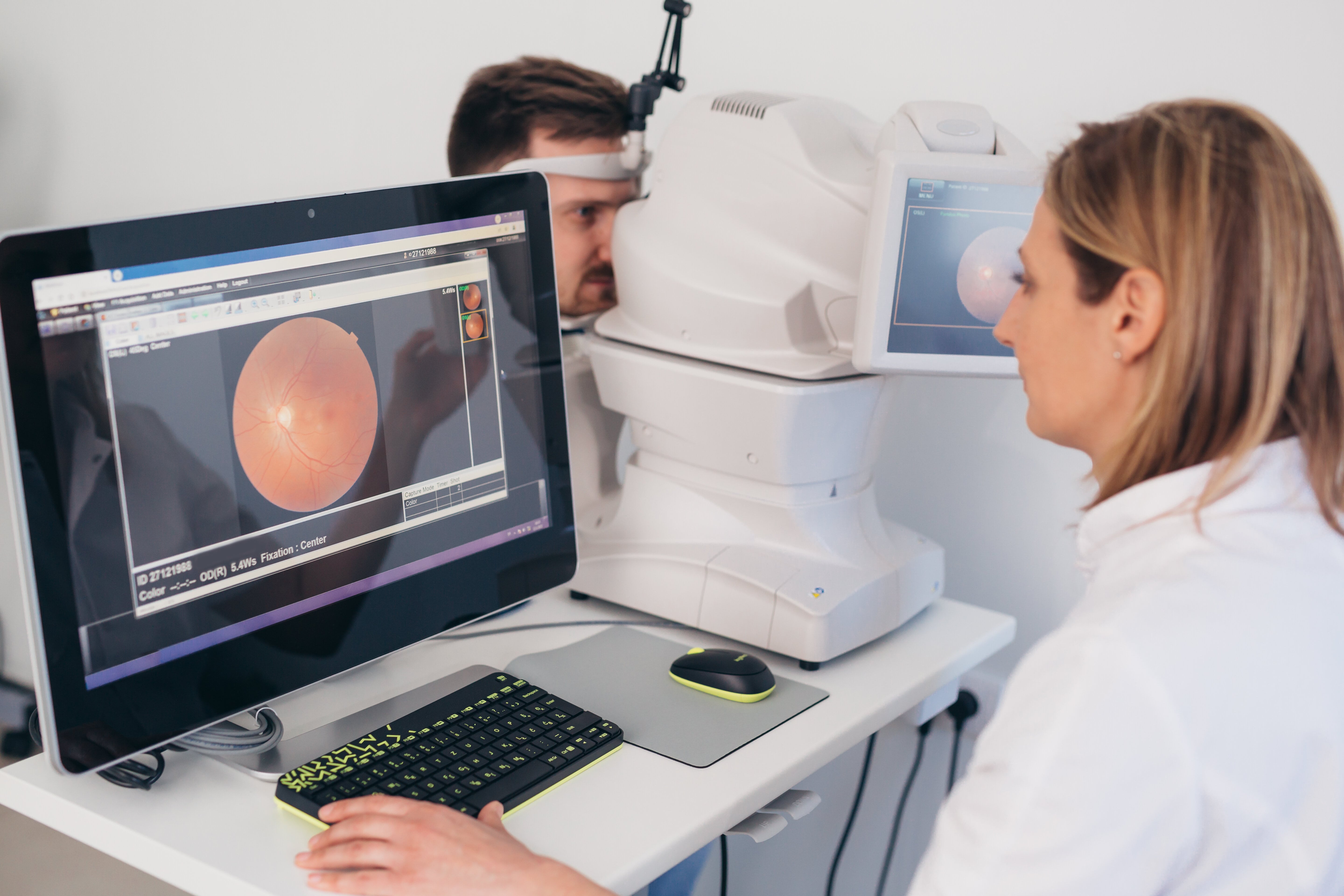 Optometrist performing retinal imaging